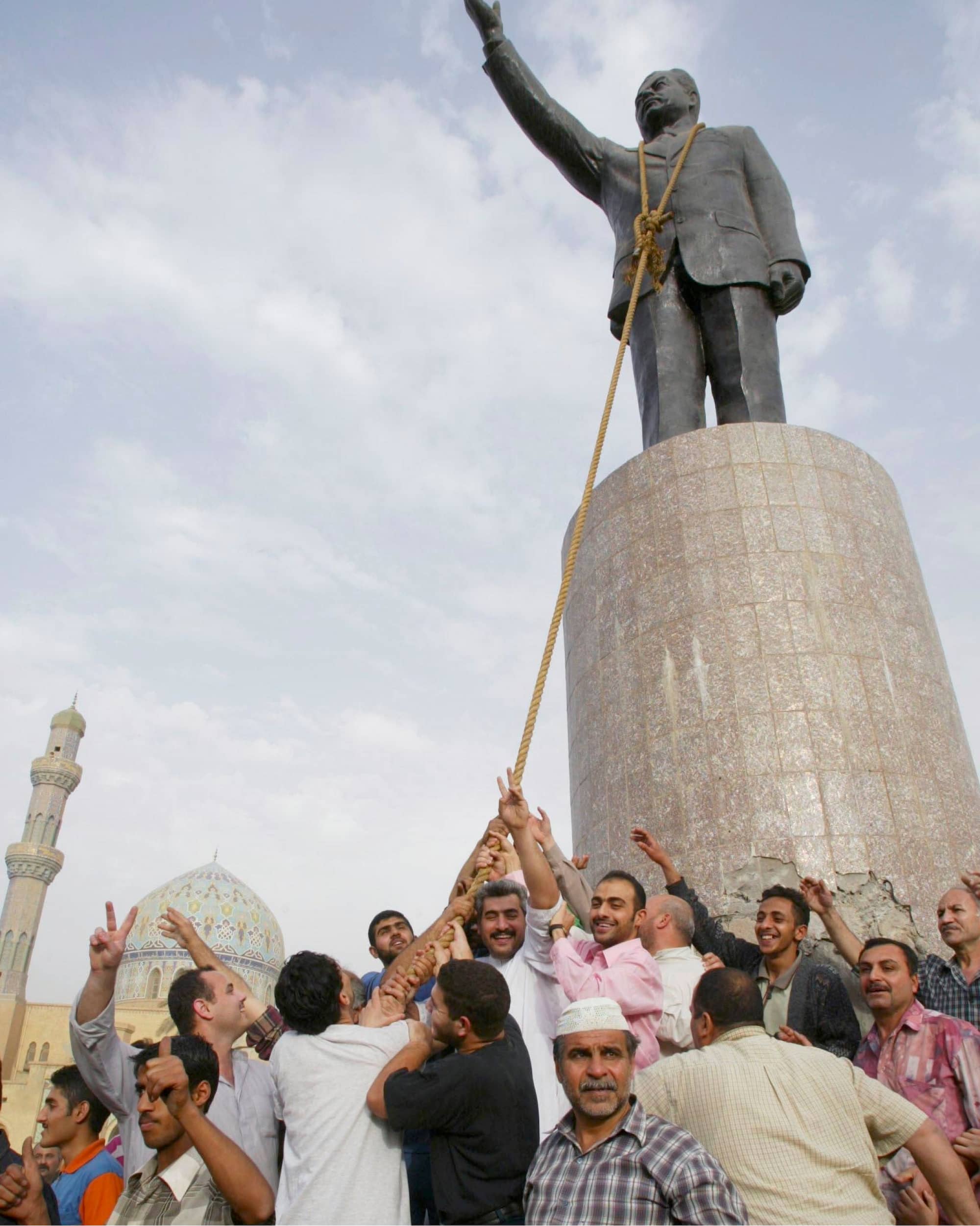 Pulling down a statue of Saddam Hussein