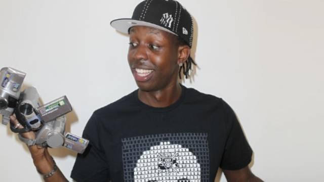 SBTV founder Jamal Edwards holding up multiple camcorders