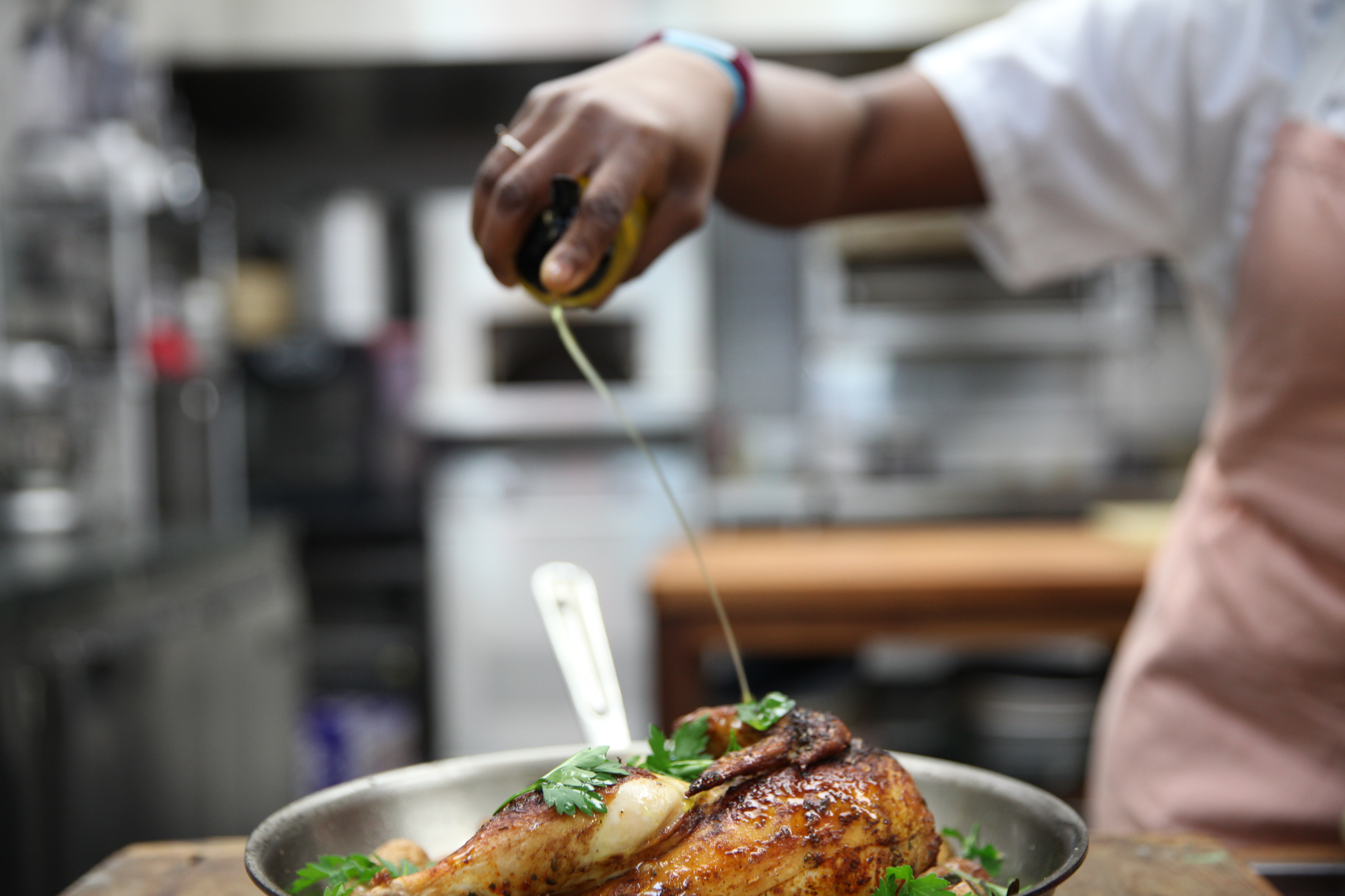 drizzling olive oil on roast chicken