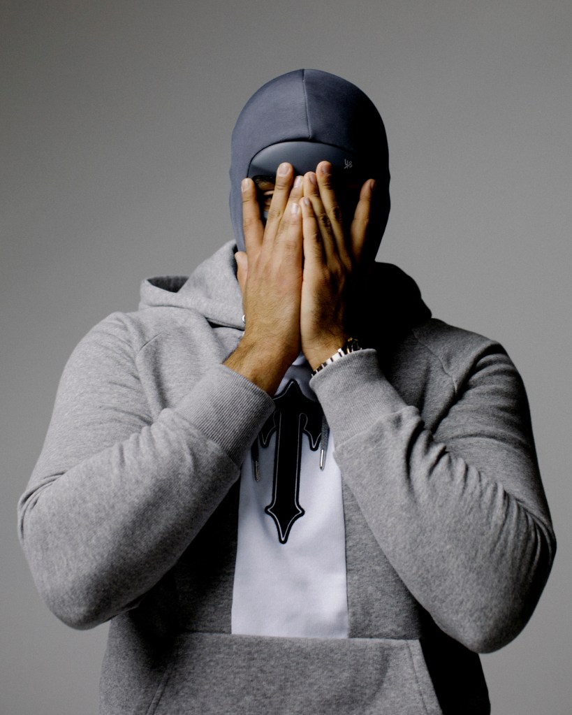 UK rapper M Huncho with hands covering face