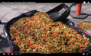 a screenshot of the video "filling chicago potholes with giardiniera" from man of the people with pat tomasulo showing a shovel inside a wheelbarrow of giardiniera and a pothole filled with giardiniera