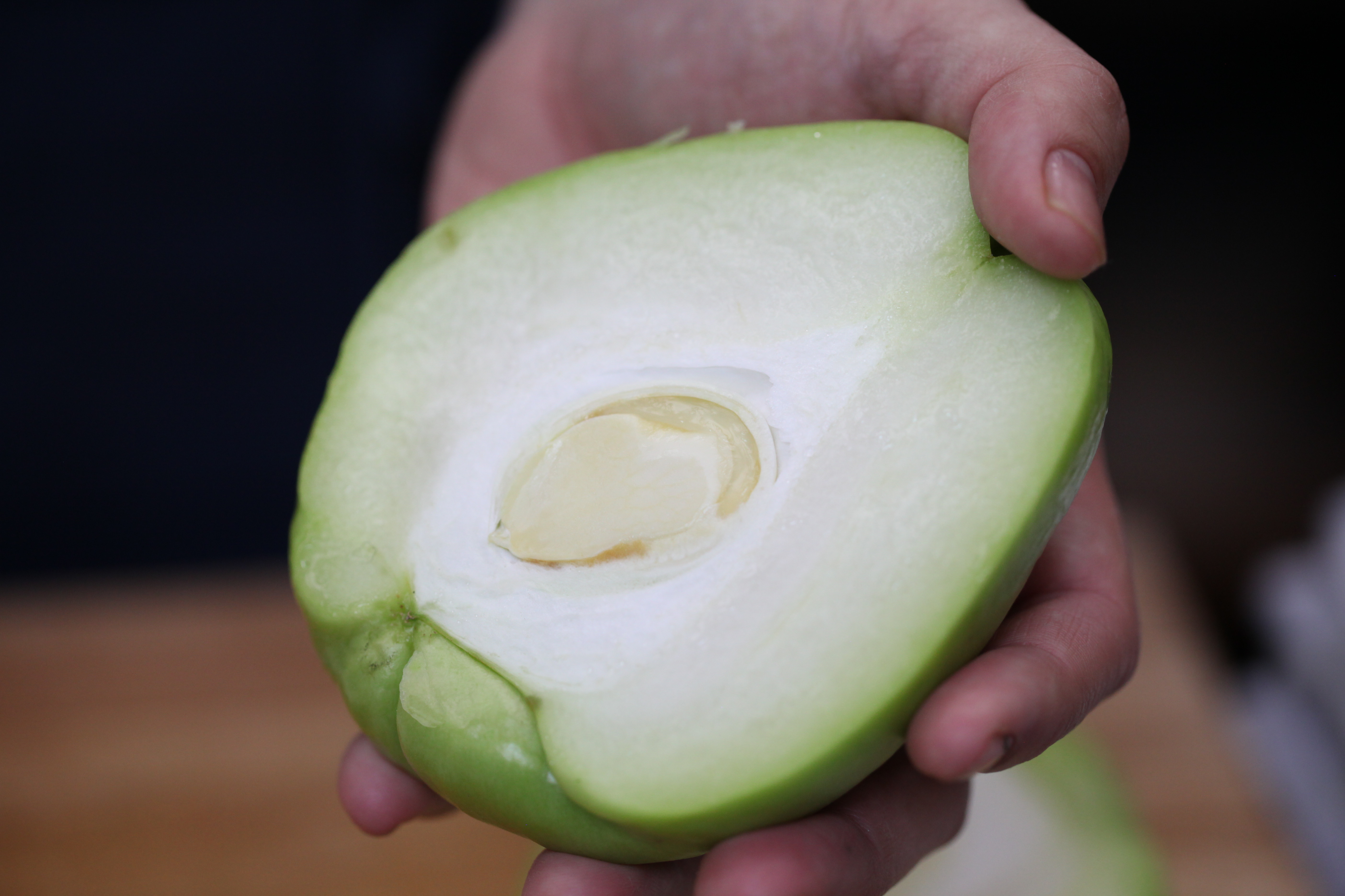 a chayote sliced in half