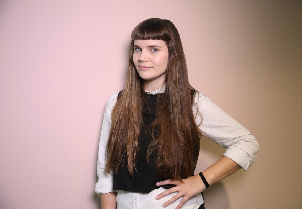 honor eastly girl against wall