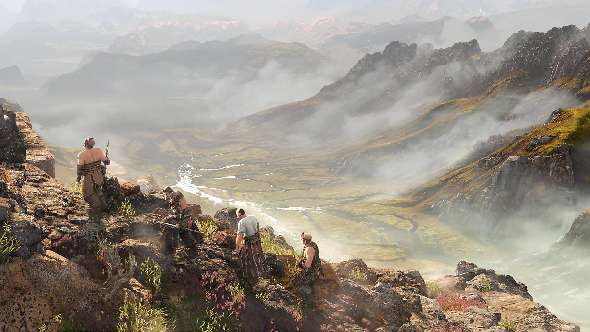 A group of figures move across a rocky mountain spine in Horizon Zero Dawn, with a cloudy valley far below