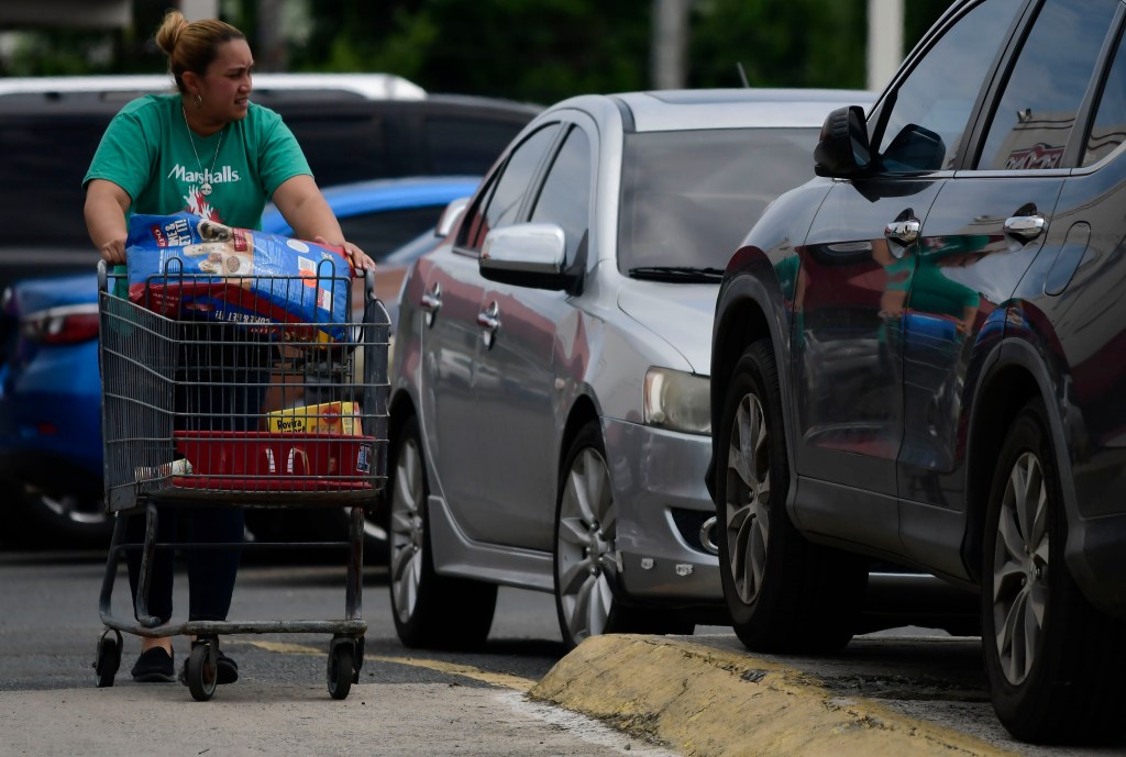 Citizens stock up on supplies a few hours before the passing of tropical storm Dorian, in Canovanas, Puerto Rico, Wednesday, Aug. 28, 2019. (AP Photo/Carlos Giusti)​