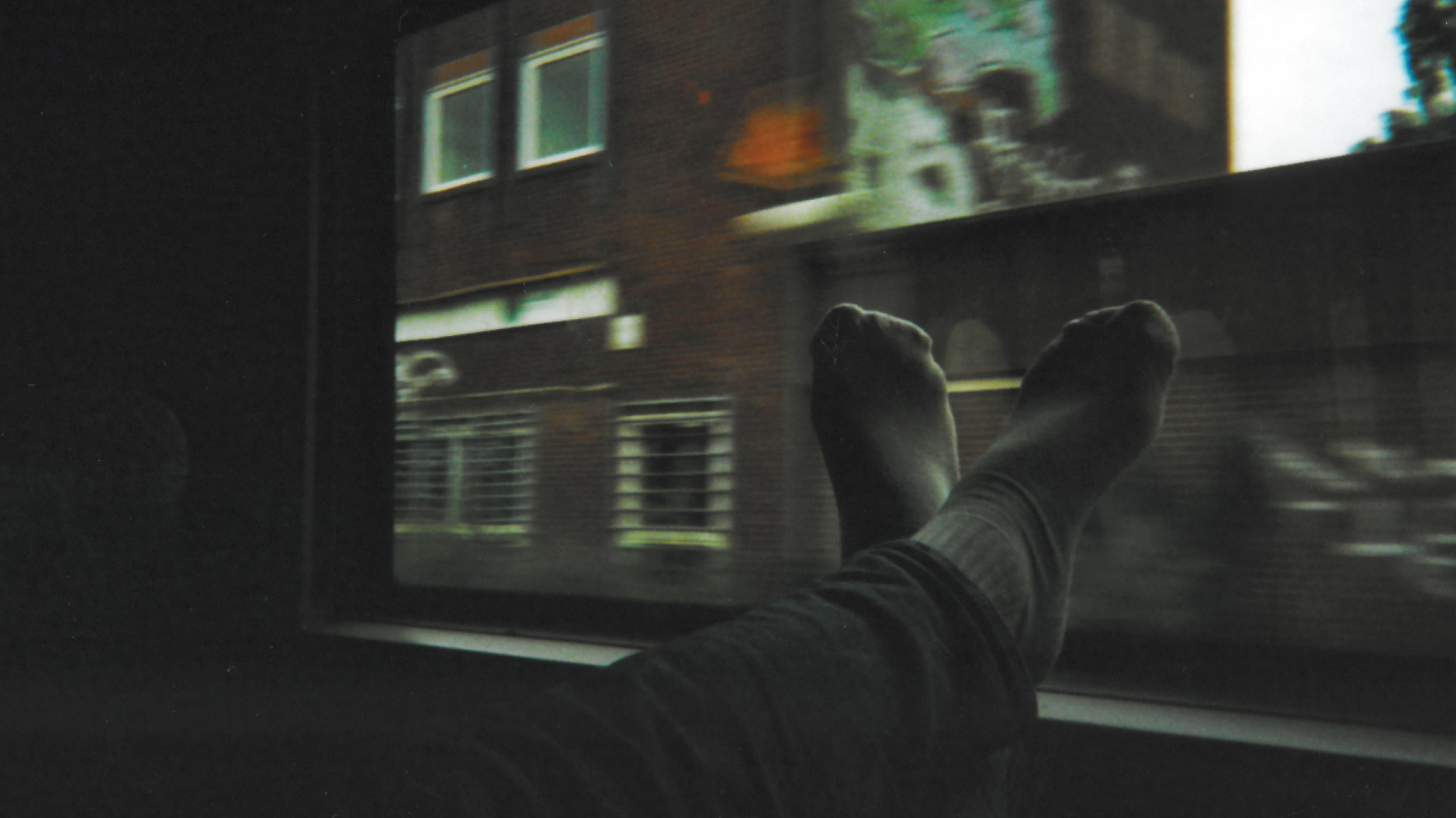 Füße vor dem Fenster des Wagons