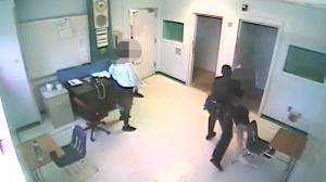 Image from surveillance video allegedly shows Broward County Sheriff's Deputy Ward Miller throwing a 15-year-old student to the ground.