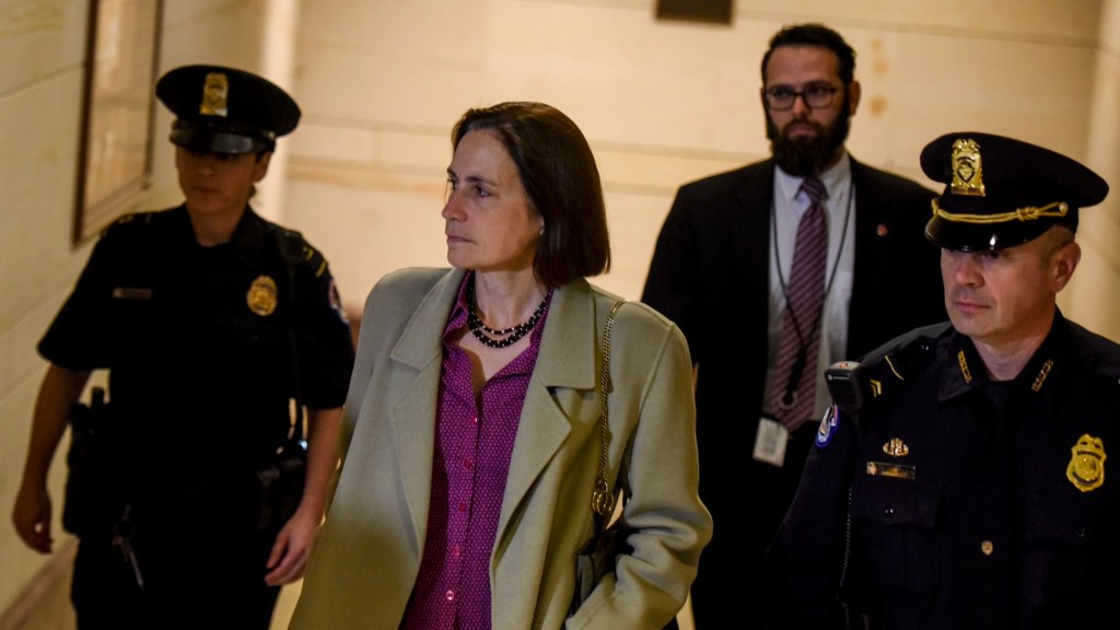 Fiona Hill, C, a foreign affairs specialist and national security official specializing in the former Soviet Union and Russian and European affairs, arrives at the U.S. Capitol for impeachment inquiry testimony before the House Intelligence Committee, Nov