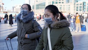 People wearing masks head for Beijing Station in Beijing, China