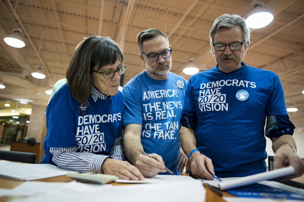 Volunteers tally votes during the first-in-the-nation Iowa caucus at the Southridge Mall in Des Moines, Iowa, U.S., on Monday, Feb. 3, 2020.