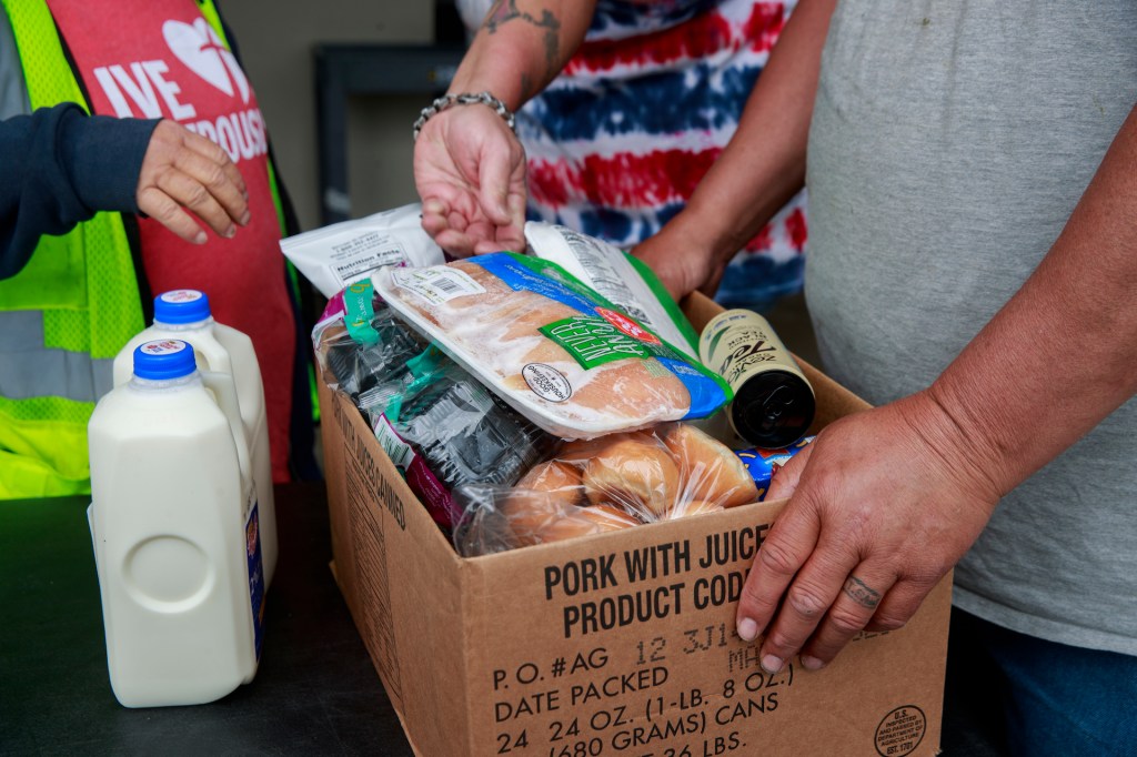Volunteers at Pantry 279 distribute food to area residents experiencing food insecurity during the COVID-19 Coronavirus emergency. (Photo by Jeremy Hogan / SOPA Images/Sipa USA)(Sipa via AP Images)