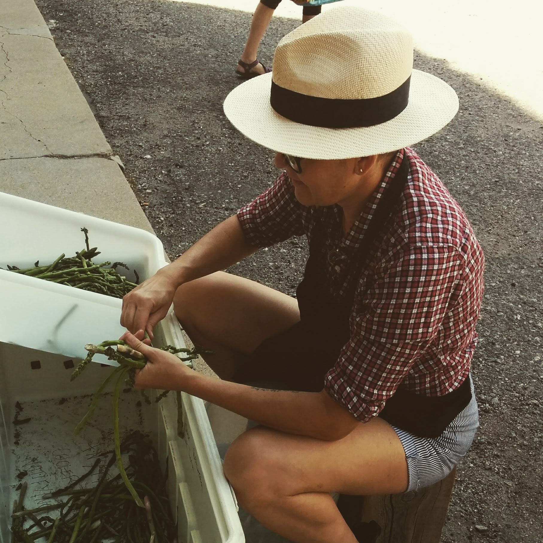 A volunteer shelling beans