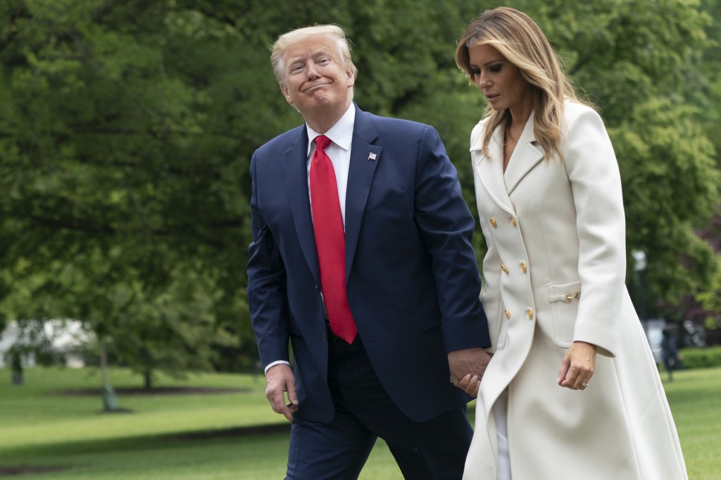 U.S. President Donald Trump and First Lady Melania Trump walk on the South Lawn of the White House after arriving on Marine One in Washington, D.C., U.S., on Monday, May 25, 2020.