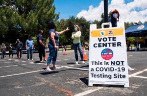 People wait to cast their votes at a polling station in Santa Clarita, California on May 12, 2020.