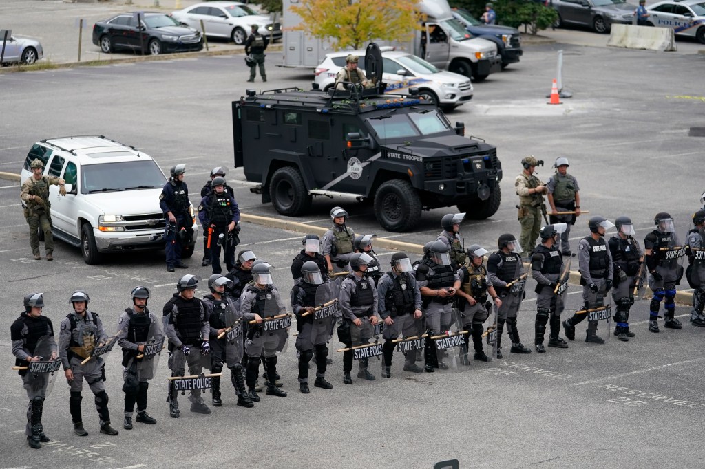 Kentucky State Police stand in a line during a protest, Wednesday, Sept. 23, 2020, in Louisville, Ky. A grand jury has indicted one officer on criminal charges six months after Breonna Taylor was fatally shot by police in Kentucky. The jury presented its