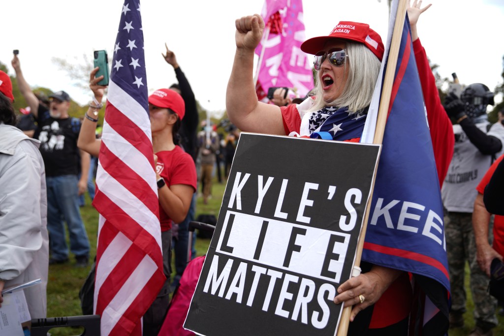 Members of the Proud Boys and other right-wing demonstrators rally on Saturday, Sept. 26, 2020, in Portland, Oregon, and hold signs of support for Kyle Rittenhouse, the 17-year-old charged in the shooting deaths of two Black Lives Matter protesters in Ken