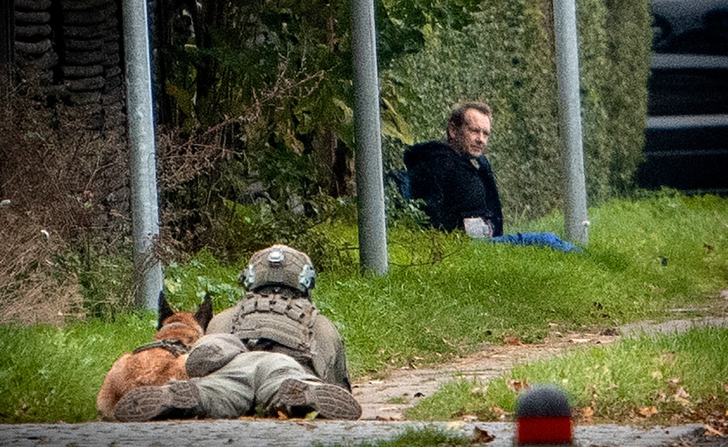 A police marksman and his dog observes convicted killer Peter Madsen threatening police with detonating a bomb while attempting to break out of jail in Albertslund, Denmark.