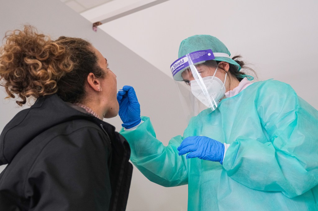 A doctor swabs a woman for COVID-19 in Padua, Italy