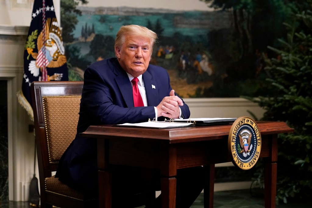 President Donald Trump speaks with reporters after participating in a video teleconference call with members of the military on Thanksgiving, Thursday, Nov. 26, 2020, at the White House in Washington. (AP Photo/Patrick Semansky)
