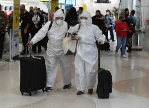 Airline Passengers Eli and Maria are seen wearing hazmat suits at Fort Lauderdale Hollywood International Airport on Thanksgiving.