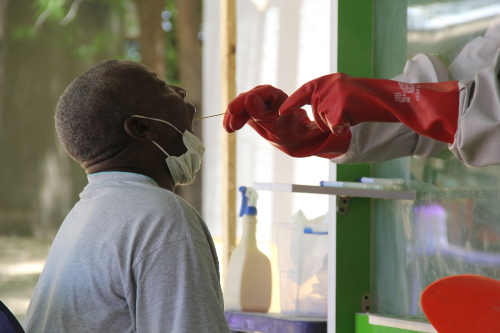 A patient who is suspected of suffering from COVID-19 coronavirus undergoes testing at the University of Maiduguri Teaching Hospital isolation centre on May 10, 2020.