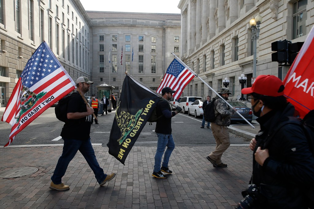 Proud Boys march with flags in Freedom Plaza during a demonstration in Washington, D.C., 12 December 2020 (Photo by John Lamparski / SOPA Images/Sipa USA)(Sipa via AP Images)