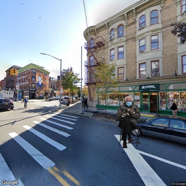 Bernie sanders sitting in the road in front of Greenlight Books.