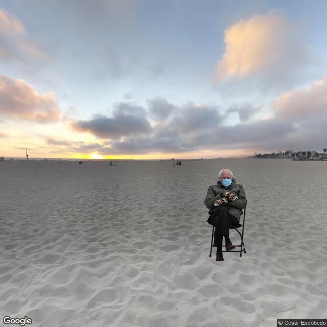 Bernie Sanders sitting on the beach.