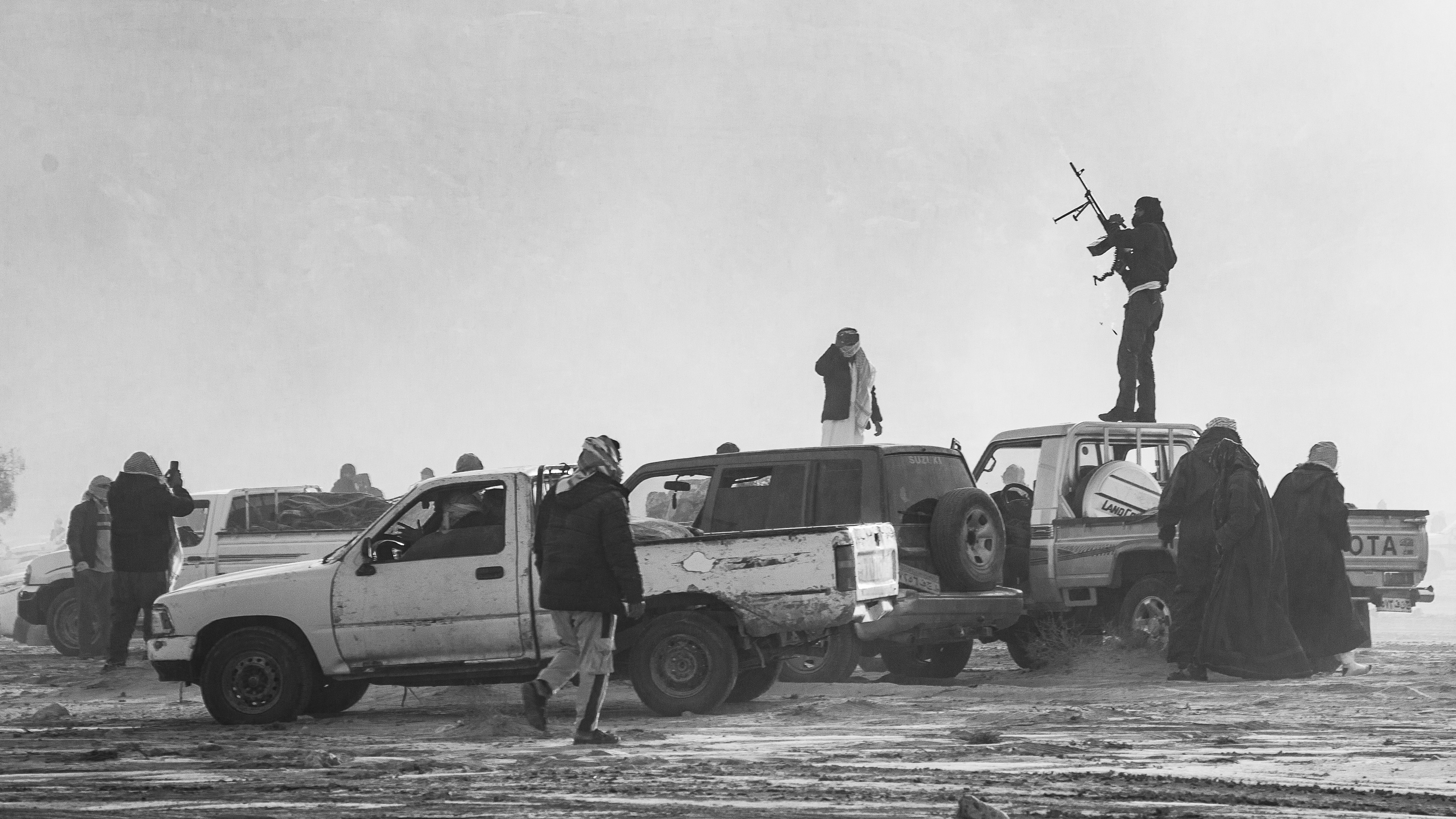 Wadi Zalaqa - Bedouin man celebrating by firing a machine gun.
