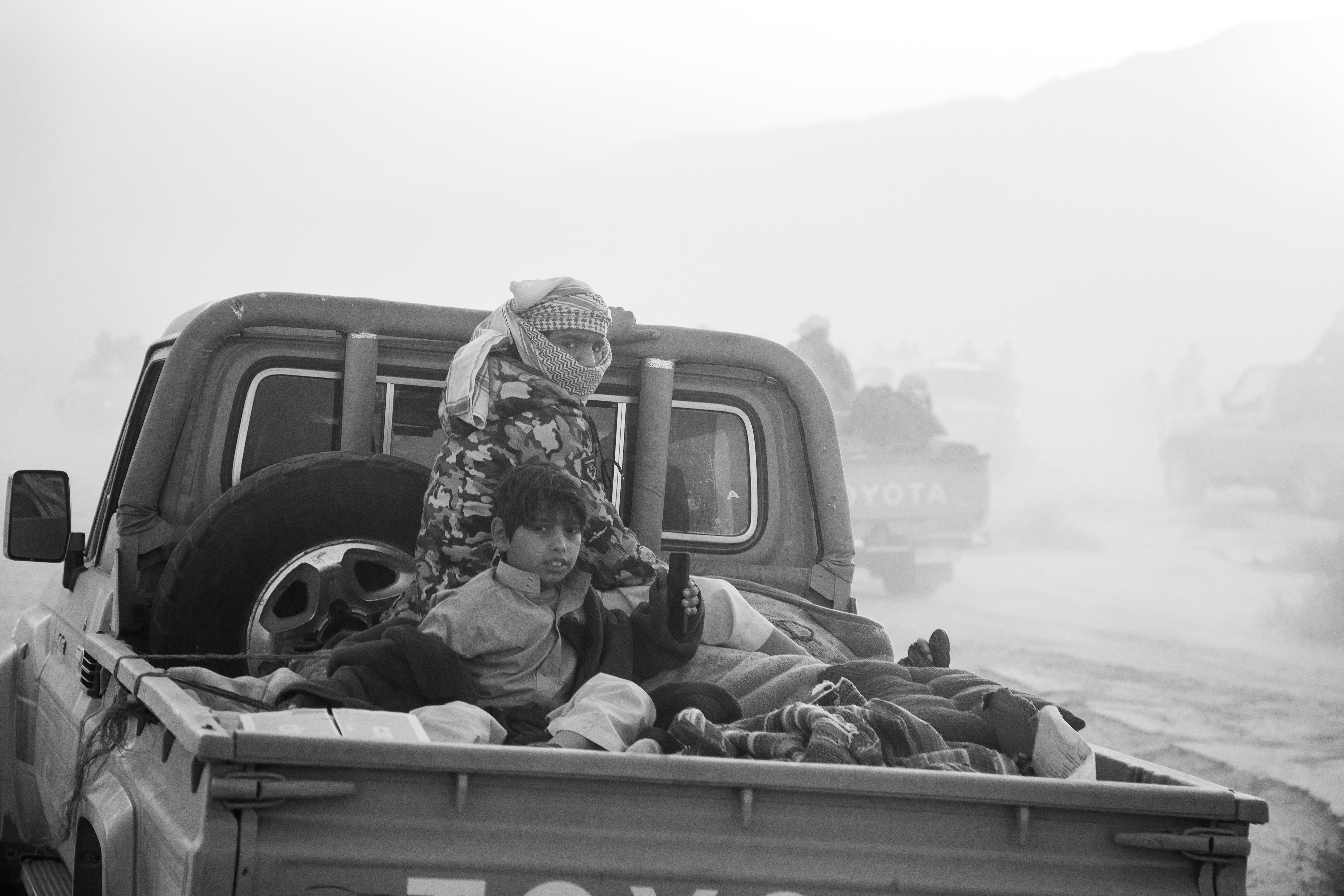 Wadi Zalaqa - A kid and a Bedouin man on the back of a pickup truck following the race.