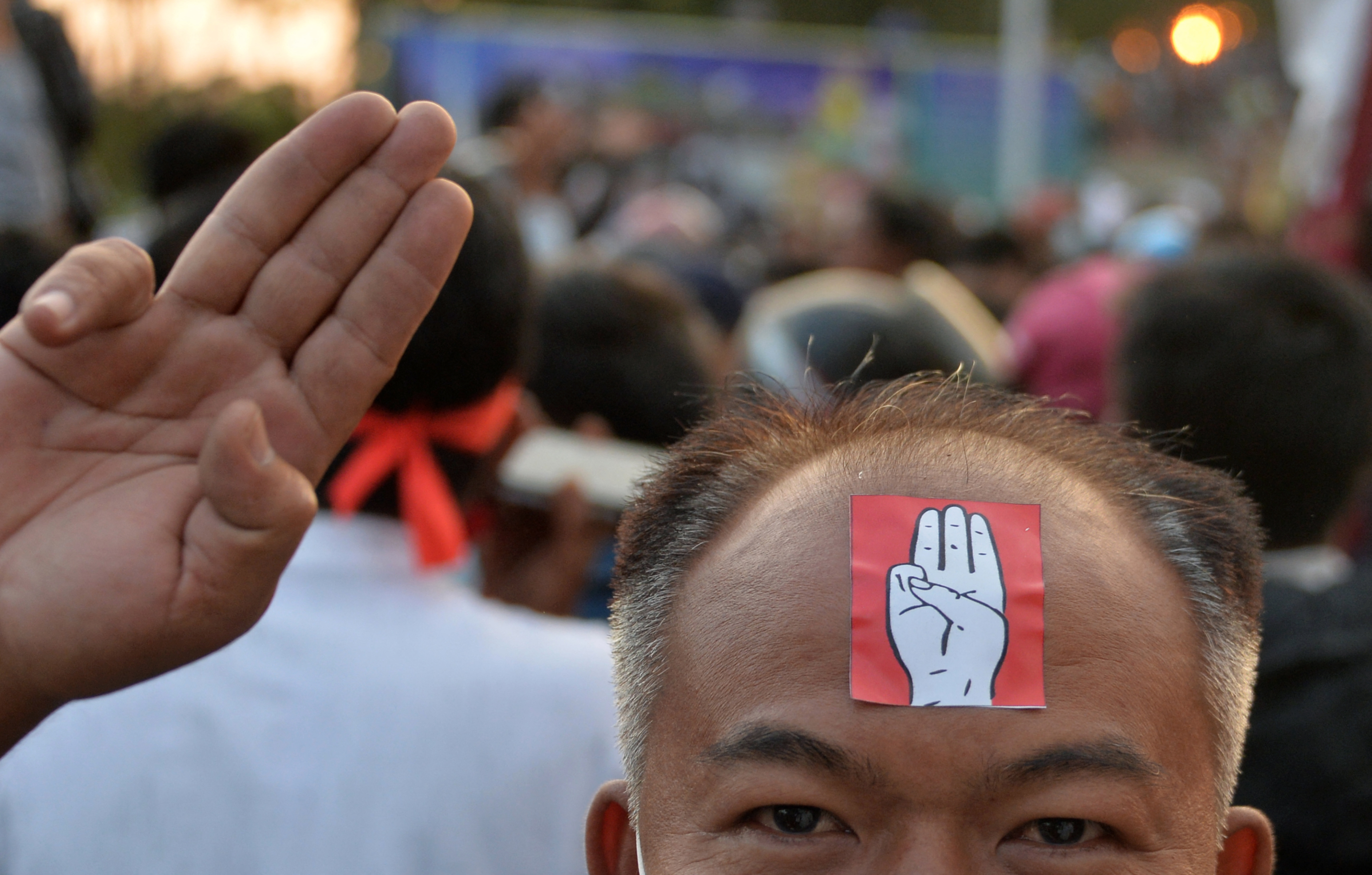 A protester in Naypyitaw holds up the three finger salute. PHOTO: AFP