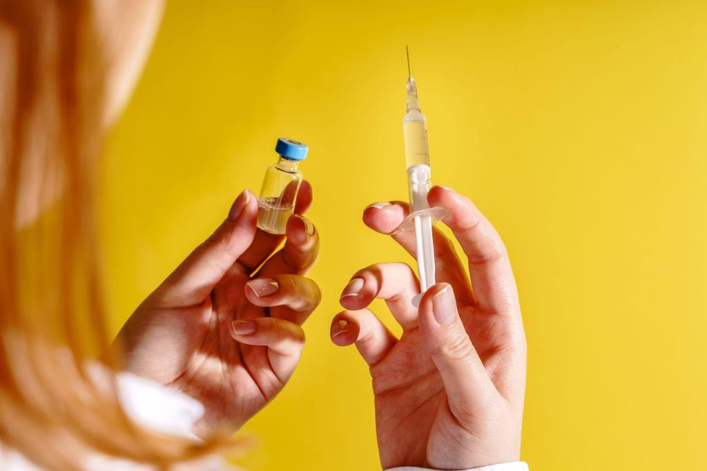 A woman holds a coronavirus vaccine