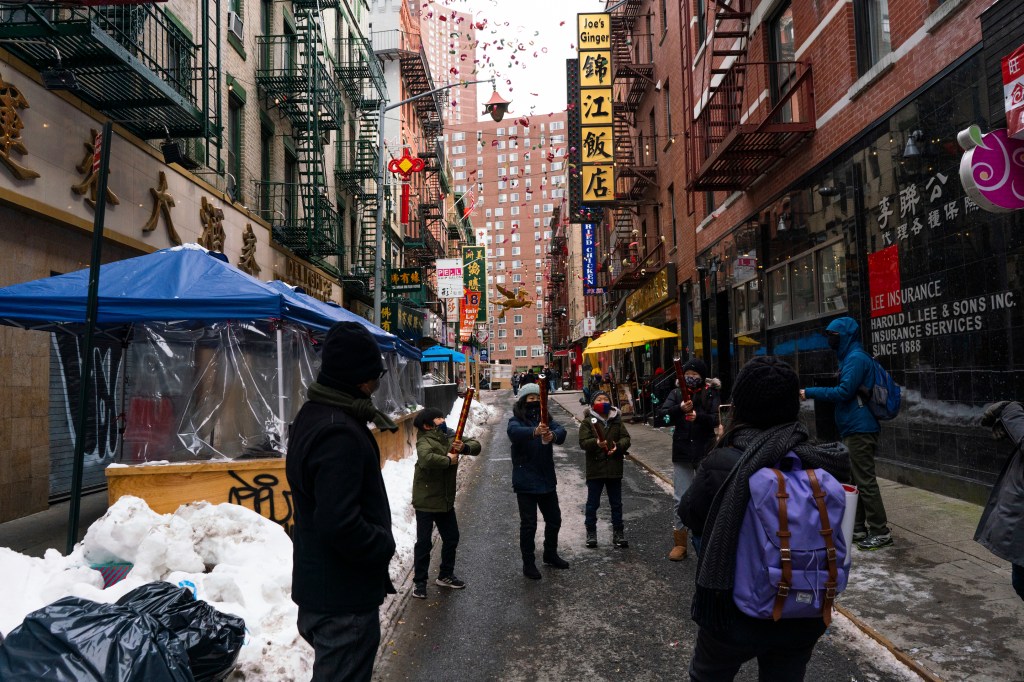 People celebrate Lunar New Year by setting off firecrackers on Friday, Feb. 2021 in Chinatown, NYC.