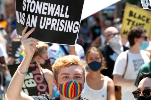 A person holds up a sign referencing the Stonewall Inn during a queer liberation march for Black Lives Matter and against police brutality, Sunday, June 28, 2020, in New York, as marchers celebrated the 50th anniversary of the gay rights movement. (AP Pho