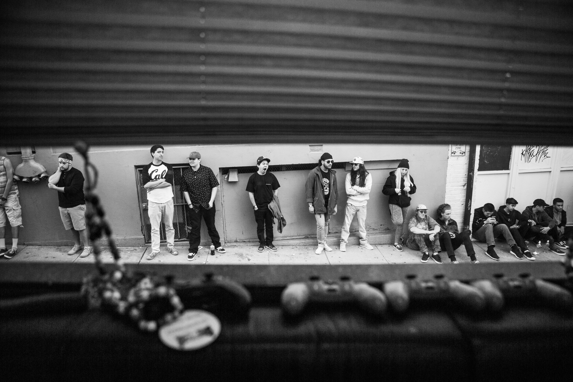 A view from a tour bus of a line of fans waiting outside.