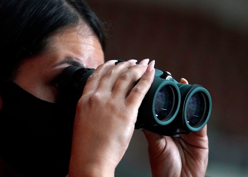 A reporter watches the Maricopa County ballots cast in the 2020 general election being examined and recounted by contractors working for Florida-based company, Cyber Ninjas, who was hired by the Arizona State Senate at Veterans Memorial Coliseum in Phoeni
