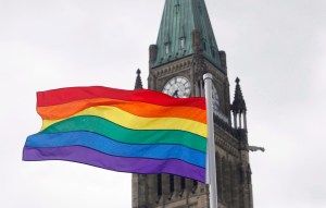 The pride flag flies in front of the Peace Tower on Parliament Hill after a flag raising ceremony in Ottawa.