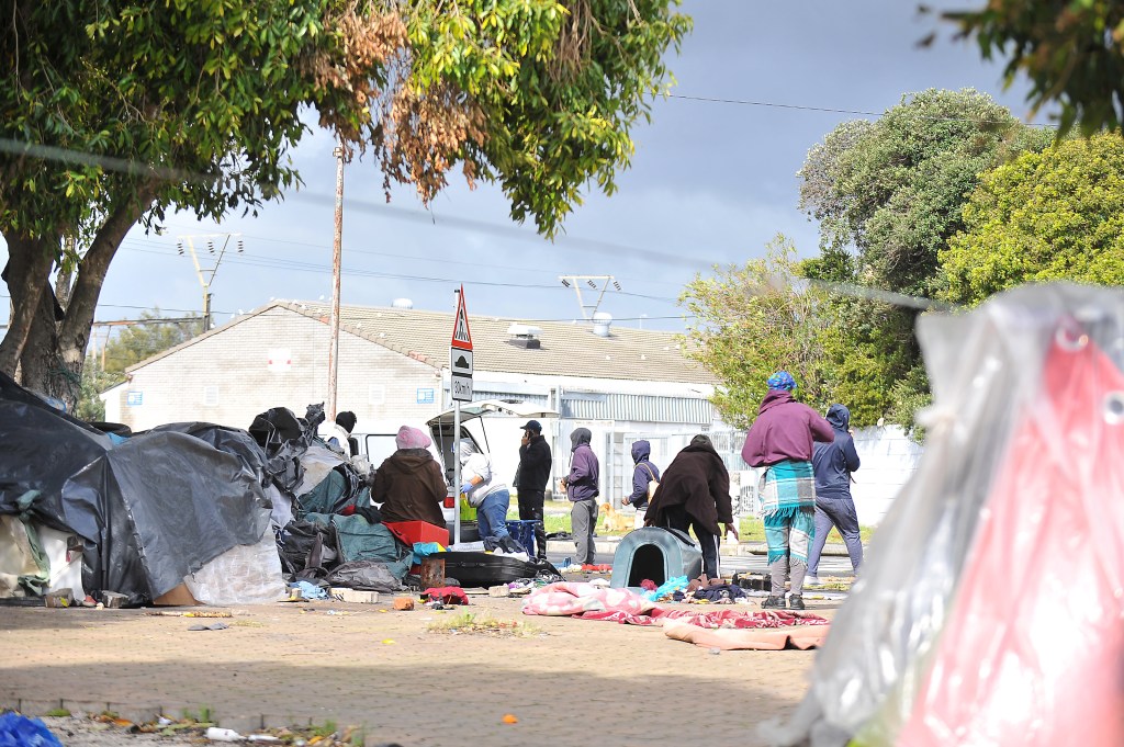 Displaced people erect homes along train lines and parking lots in Lansdowne on August 12, 2020 in Cape Town.