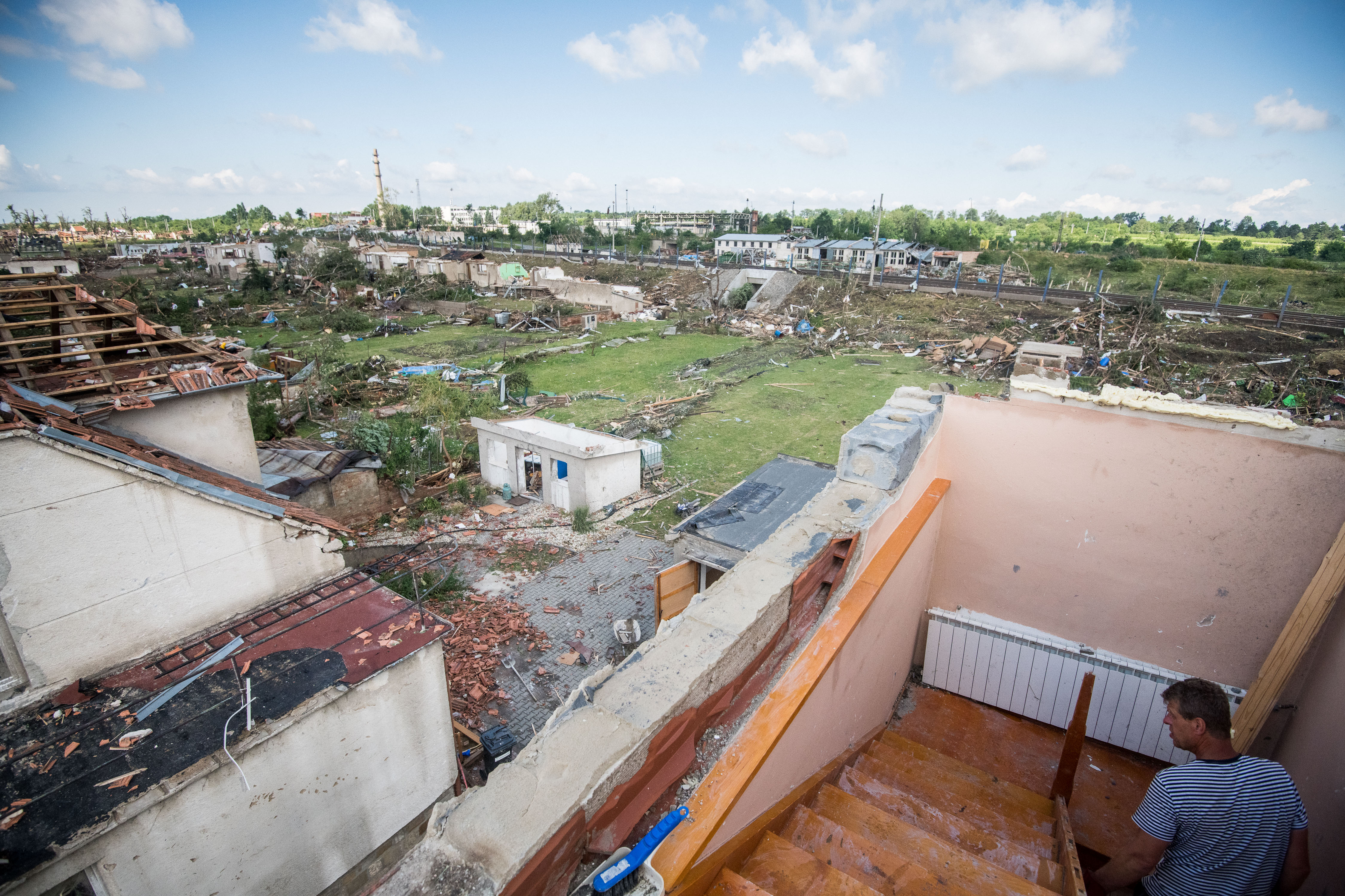 The owner of a destroyed house walks to what used to be an attic, in Mikulice. Photo: Robert Barca/Getty Images