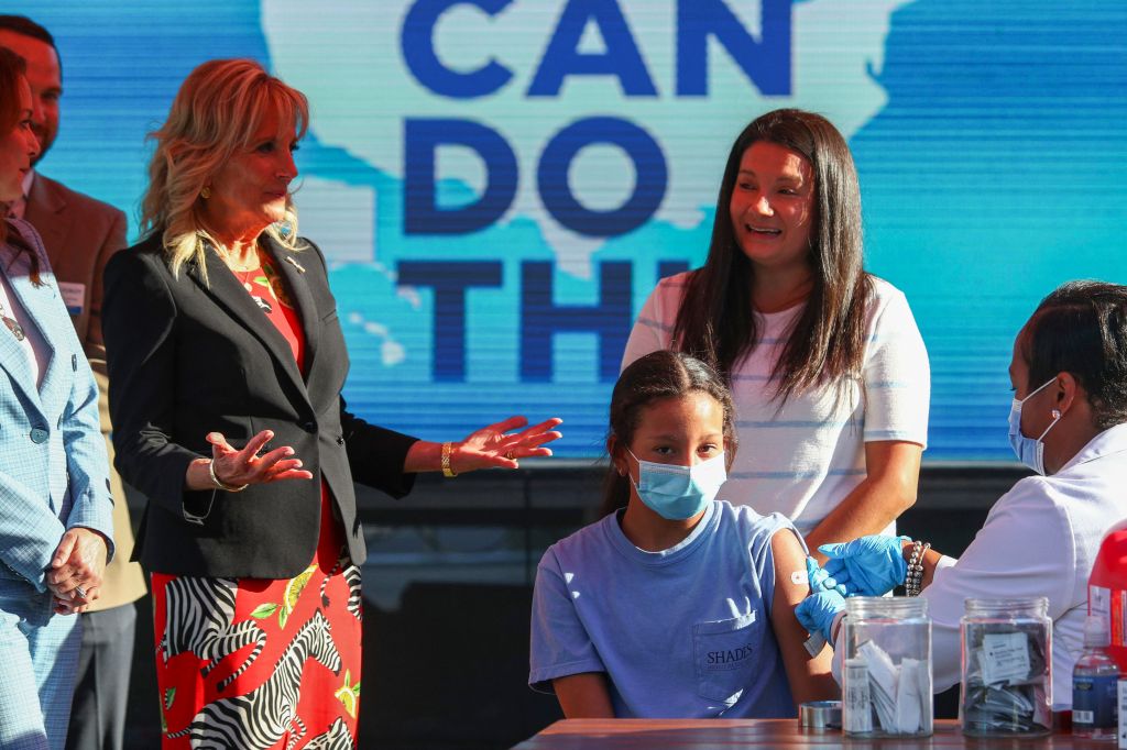 US first lady Jill Biden (L) gestures as Adriana Lyttle, 12, receives her vaccine at a Covid-19 vaccination site at Ole Smoky Distillery in Nashville, Tennessee, June 22, 2021. (Photo by TOM BRENNER / POOL / AFP) (Photo by TOM BRENNER/POOL/AFP via Getty I