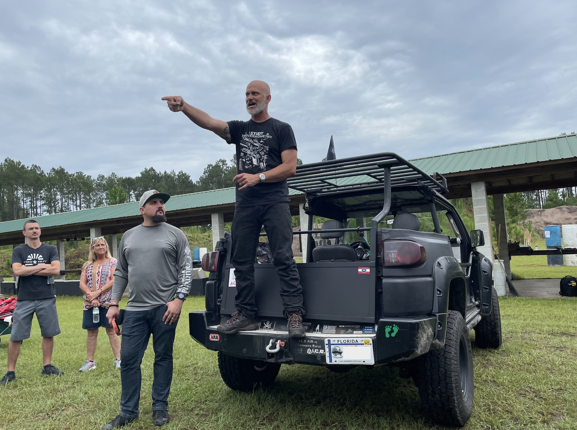 Rob Pincus (right) and Xander Guetzloe, a moderator of the group Are We Cool Yet?, address the crowd at the