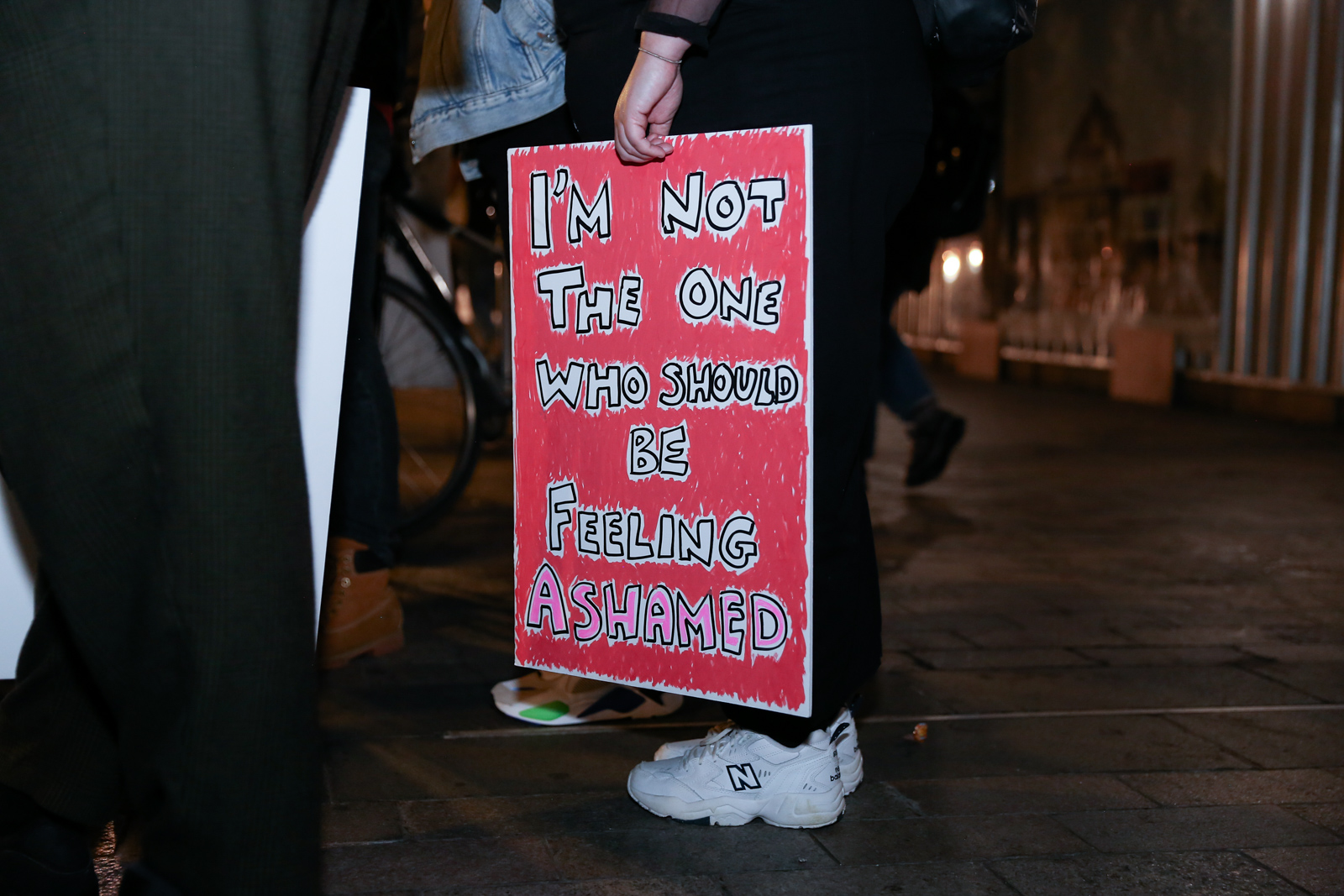 A close-up of a protest sign reading