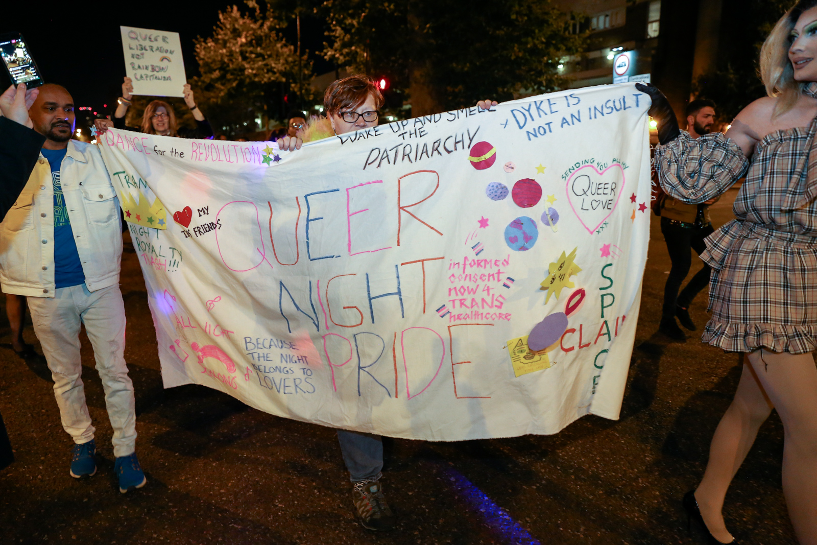 A banner reading Queer Night Pride