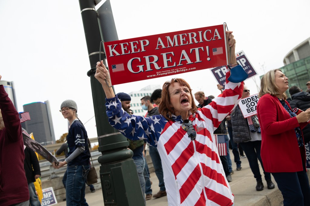A Trump supporter holds a sign at a protest during the 2020 Presidential election outside the TCF Center in Detroit, Michigan, U.S., on Thursday, Nov. 5. 2020 (Emily Elconin/Bloomberg via Getty Images​)