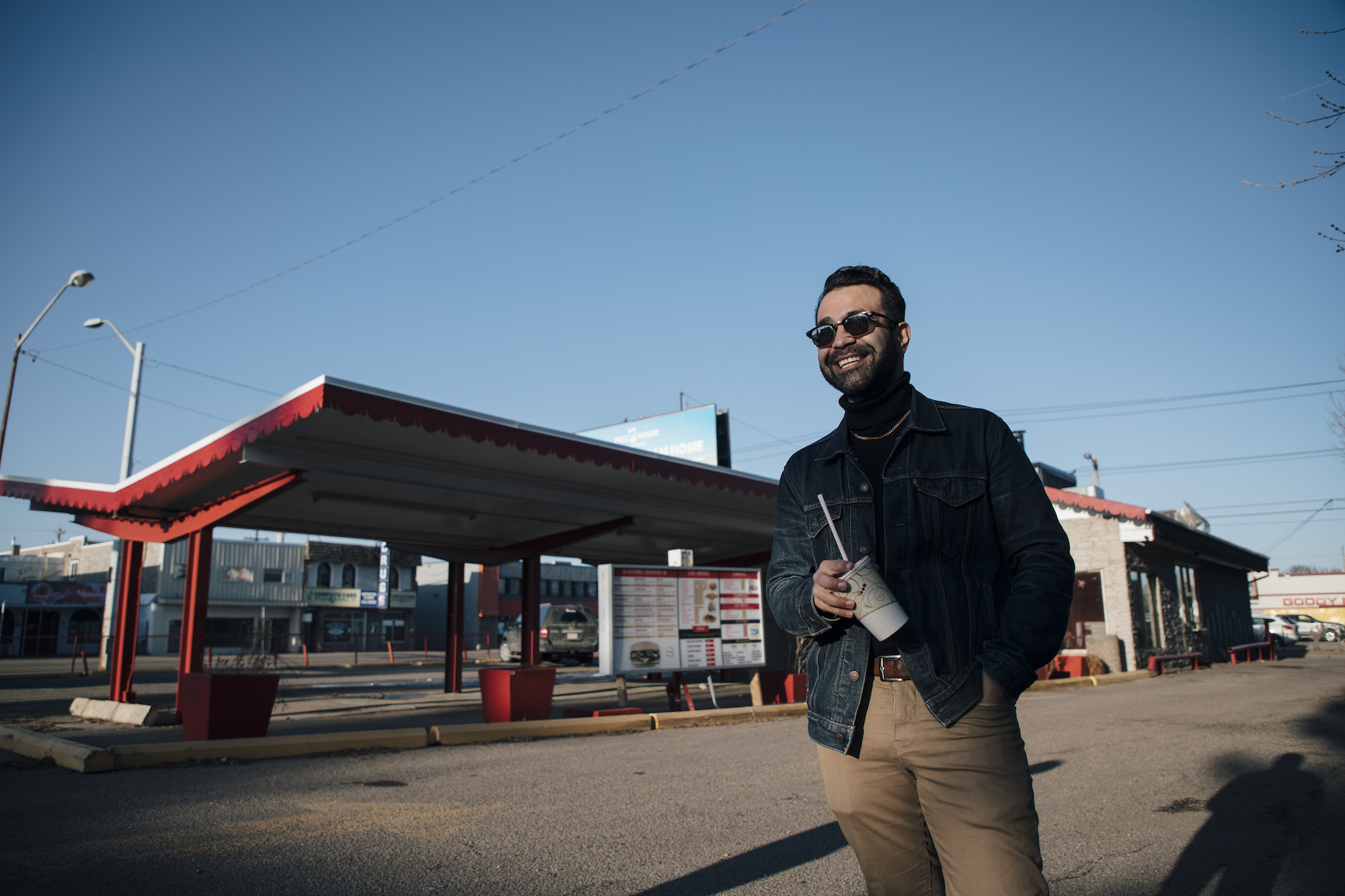 Omar Mouallem stands in front of a Burger Baron in Edmonton. Photo by Amber Bracken/Back Road Productions