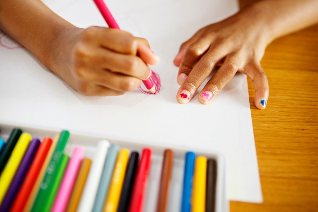 Girl drawing with colored pencils