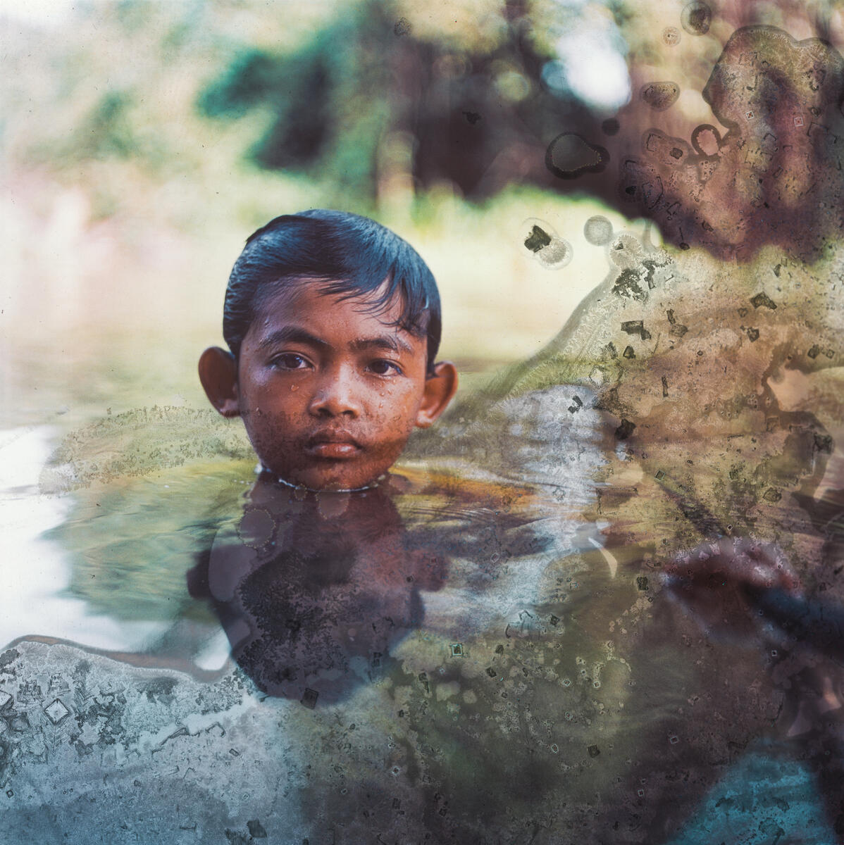 MengHy, 12, swimming by his grandfather's floating house on Tonlé Sap Lake, Kompong Thom province, Cambodia. Image: Lim Sokchanlina / Save the Children
