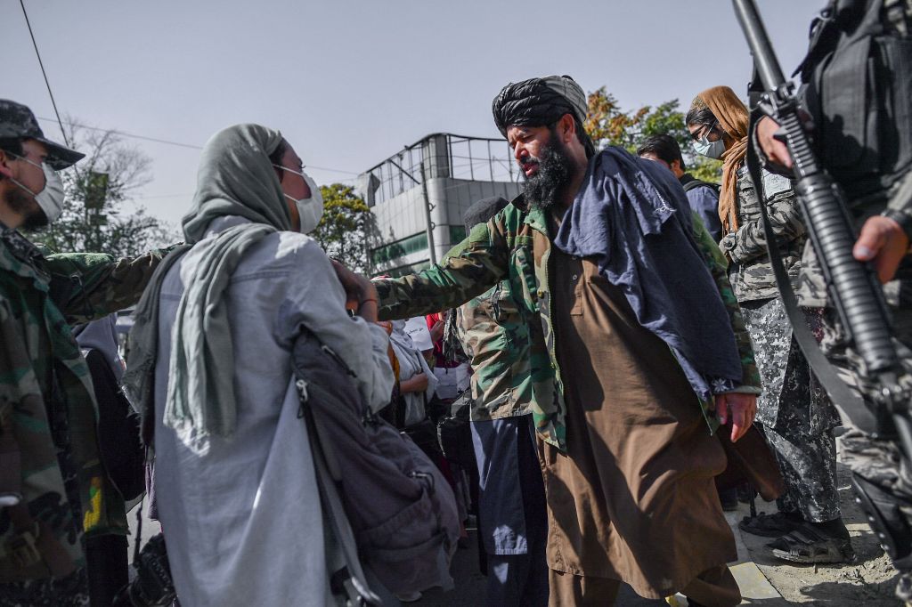 Taliban members stop women protesting for women's rights in Kabul on October 21, 2021.
