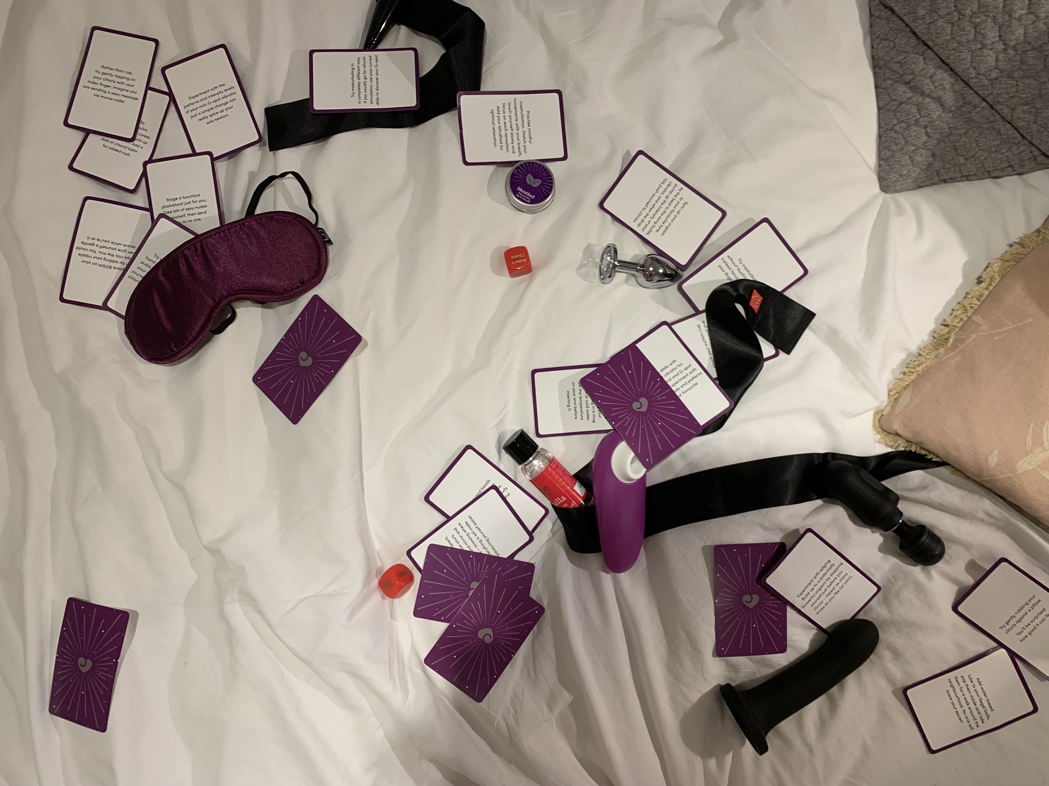 The sex toys are scattered over the bed.