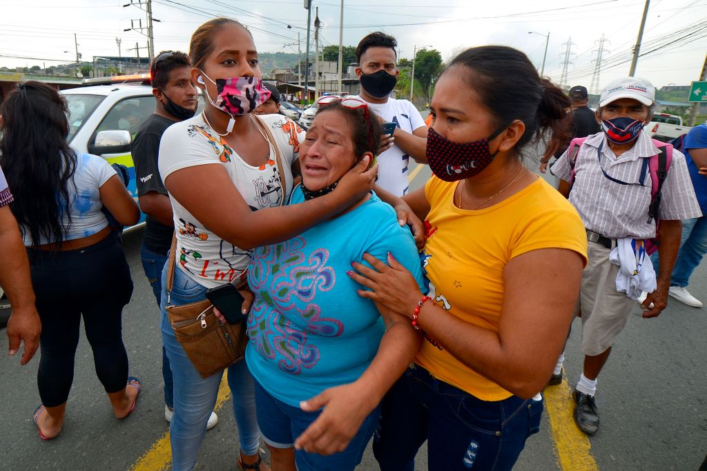 Relatives wait for news outside of an Ecuador prison after riots left over 50 dead in February 2021.